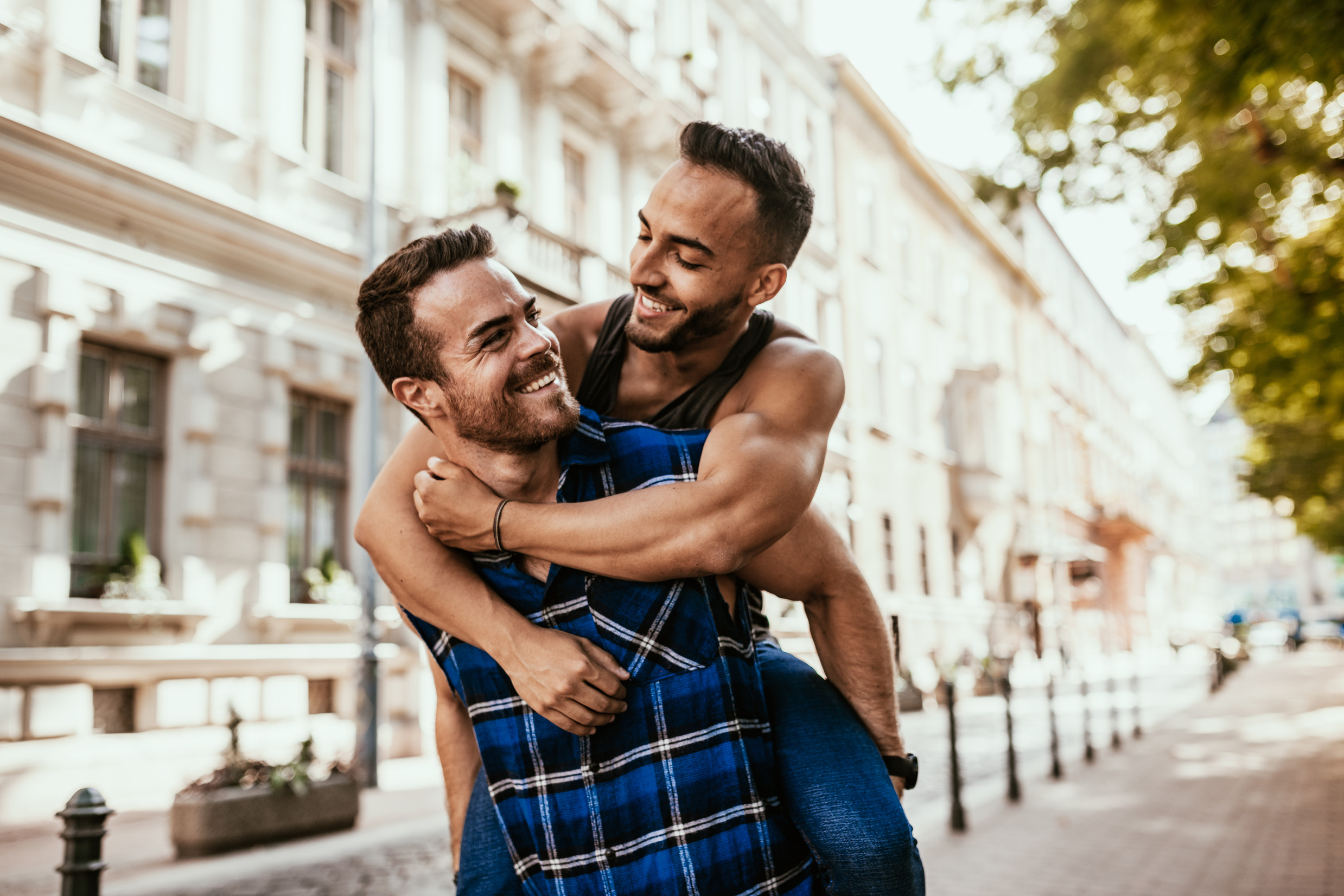 Multi-ethnic LGBT or gay couple traveling in summer